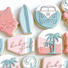 decorated cookies are arranged in the shape of surfboards and palm trees, along with beach themed cookies