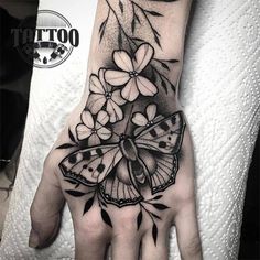 a hand with a butterfly and flowers on it