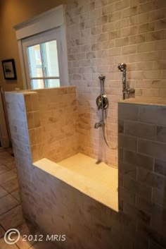 a bathroom with a walk in shower next to a window