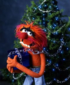 the muppet is chained to a christmas tree