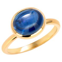 Introducing our exquisite Ceylon Cabochon Sapphire Ring, a stunning piece that effortlessly combines timeless elegance with modern craftsmanship. This captivating ring features a mesmerizing 4.83-carat Ceylon cabochon sapphire, renowned for its rich, velvety blue hue and exceptional quality. The gemstone is securely nestled in a lavish 14-karat yellow gold bezel setting, creating a seamless and sophisticated look. The bezel setting not only adds a touch of contemporary style but also ensures the sapphire is held securely in place, allowing its natural beauty to take center stage. The ring is designed with meticulous attention to detail, showcasing the seamless marriage of classic charm and contemporary aesthetics. The 14-karat yellow gold band complements the sapphire's deep blue tones, cr Blue Cabochon Sapphire Ring, Gold Sapphire Cabochon Ring, Gold Cabochon Sapphire Ring In 14k Gold, Luxury Elegant Cabochon Sapphire Ring, Luxury Sapphire Cabochon Ring, Gemstone Solitaire Ring, Sapphire Solitaire Ring, White Gold Solitaire, Gold Solitaire Ring