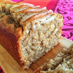 sliced loaf of banana bread sitting on top of a wooden cutting board