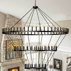 a large chandelier with candles hanging from it's sides in a living room