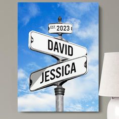 a lamp is next to a street sign with the name david and jessica on it