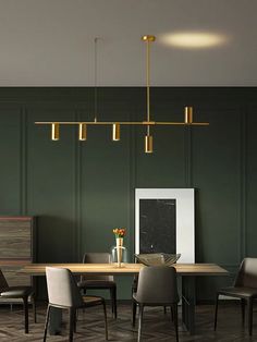 an elegant dining room with green walls and wood flooring is pictured in this image