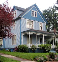 a blue house with white trim and windows