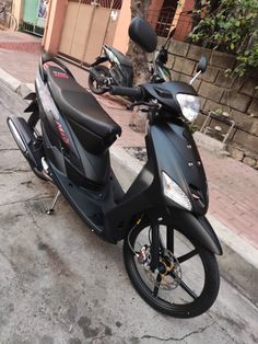 a motor scooter parked on the side of the road