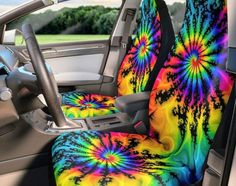 the interior of a car with colorful tie - dyed seat covers