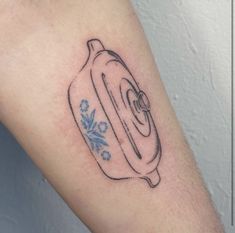 a tattoo on the arm of a person with a blue and white flowered design