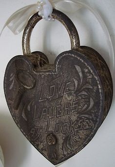 a heart shaped lock hanging on the wall