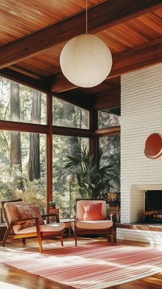 a living room filled with furniture and a fire place in front of a large window