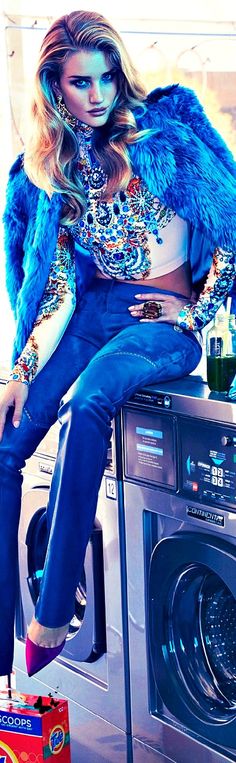 a woman sitting on top of a washing machine