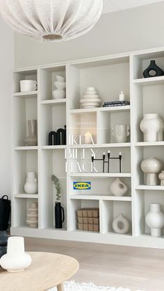 a living room filled with lots of white shelves