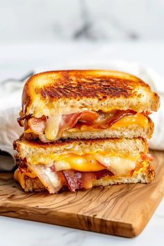 a grilled cheese and bacon sandwich on a cutting board