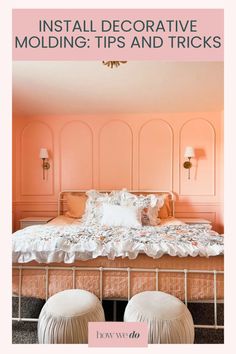 a bedroom with pink walls and white bedding, two stools in front of the bed