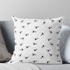 a white pillow with black triangles on it