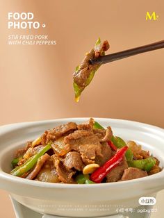 a white bowl filled with food and chopsticks sticking out of the meat in it