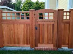 a wooden gate in front of a house