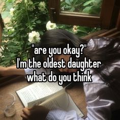 a woman sitting at a table with an open book in front of her and the caption are you okay? i'm the oldest daughter what do you think