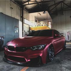 a red car is parked in a garage