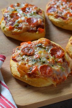 mini pizzas with cheese and pepperoni on a cutting board