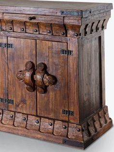 an old wooden cabinet with carvings on the doors