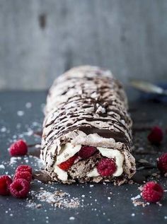 a piece of chocolate and raspberry ice cream roll on top of a table