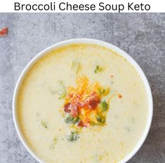 a bowl of soup with broccoli, cheese and bacon