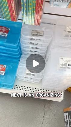 plastic containers are stacked on top of each other in front of the store's shelves