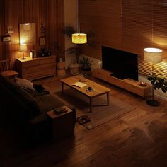 a living room filled with furniture and a flat screen tv sitting on top of a wooden table