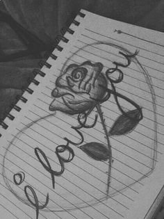 a drawing of a rose with the word roses written in cursive writing on lined paper