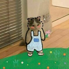 a paper cut out of a cat wearing overalls and standing on the ground in front of a door