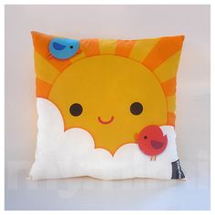 a pillow with a bird and sun on it