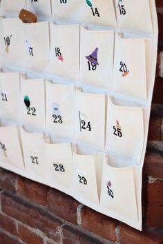 a white calendar hanging on a brick wall