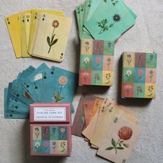 an assortment of playing cards with flowers on them