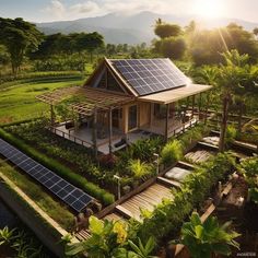 an aerial view of a house with solar panels on the roof and landscaping around it