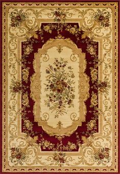 a red and beige rug with an ornate design on the center, surrounded by flowers