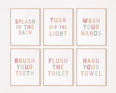 four bathroom wall art prints with the words wash, brush, and toliet