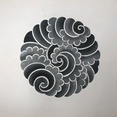 a drawing of an intricately designed object in black and white on a sheet of paper