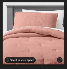 an image of a bed with pink comforter and pillows on the headboard that says see it in your space