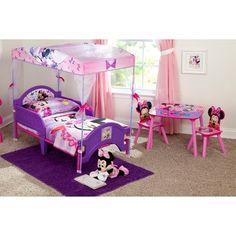 a child's bedroom with minnie mouse furniture and accessories, including a canopy bed