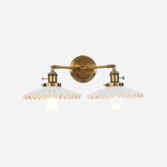 two light brass bathroom fixture with white glass shades