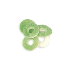 three green donuts sitting on top of each other in front of a white background