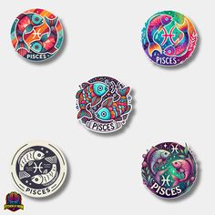 four badges with different designs on them in the shape of fish and zodiac signs, all depicting pisces