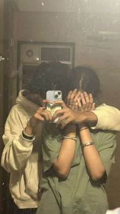 two people hugging each other in front of a mirror