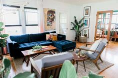 a living room filled with furniture and plants