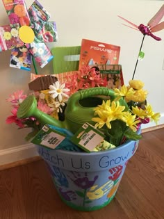 a bucket filled with flowers and gardening items