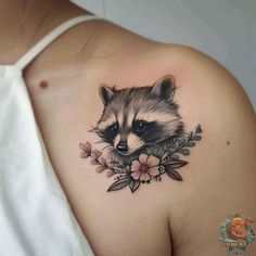 a raccoon with flowers on the shoulder