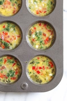 six muffin tins filled with different types of breakfast foods on top of a marble counter