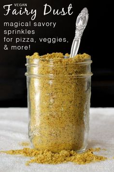 a jar filled with yellow powder next to a spoon